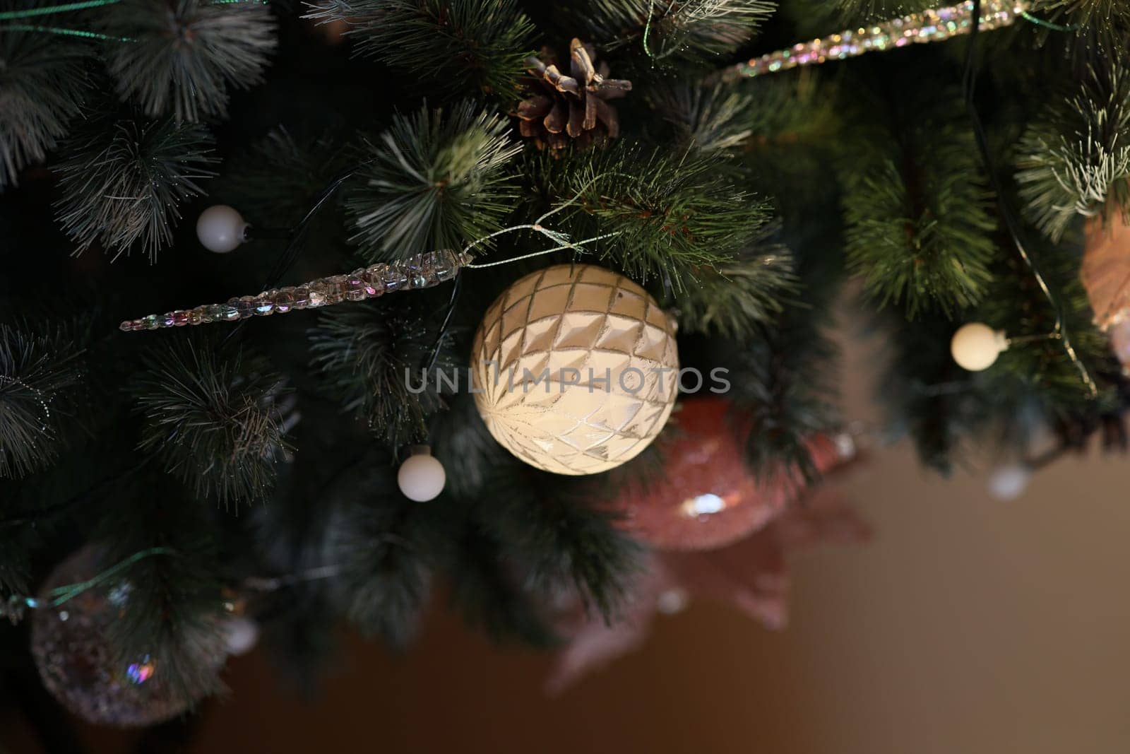 Beautiful decorative ornaments and lush greenery adorning a Christmas tree, perfectly capturing the festive spirit
