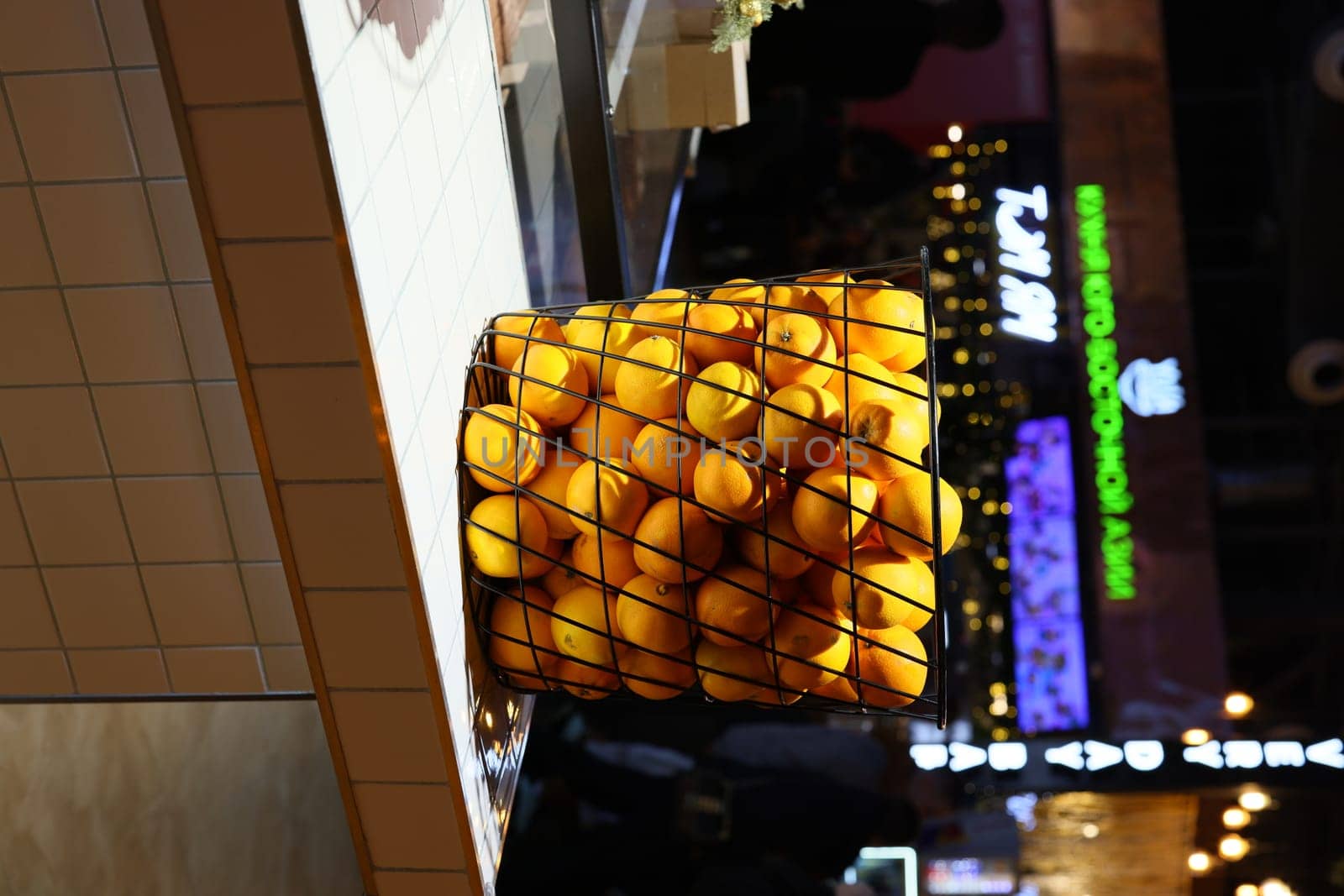 A vibrant and colorful basket brimming with fresh, juicy oranges, ideal for food markets and healthy living themes