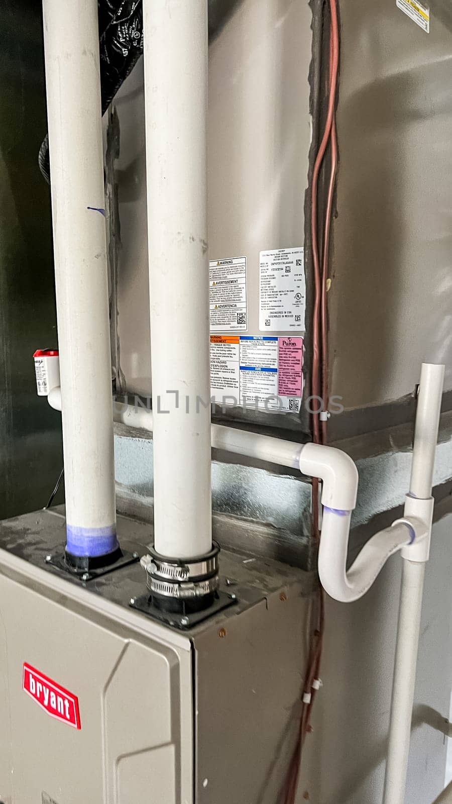 Parker, Colorado, USA-January 11, 2023-Close-up view of two vertical PVC pipes connected to the home HVAC system, located in the basement of a newly constructed residential home. These pipes are part of the ventilation and exhaust system to regulate airflow and maintain proper indoor air quality.