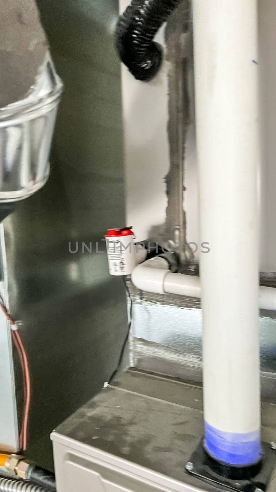 Parker, Colorado, USA-January 11, 2023-Close-up view of two vertical PVC pipes connected to the home HVAC system, located in the basement of a newly constructed residential home. These pipes are part of the ventilation and exhaust system to regulate airflow and maintain proper indoor air quality.