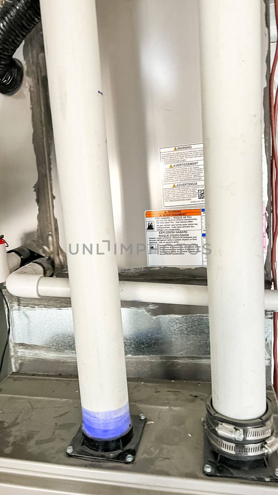 Parker, Colorado, USA-January 11, 2023-Close-up view of two vertical PVC pipes connected to the home HVAC system, located in the basement of a newly constructed residential home. These pipes are part of the ventilation and exhaust system to regulate airflow and maintain proper indoor air quality.