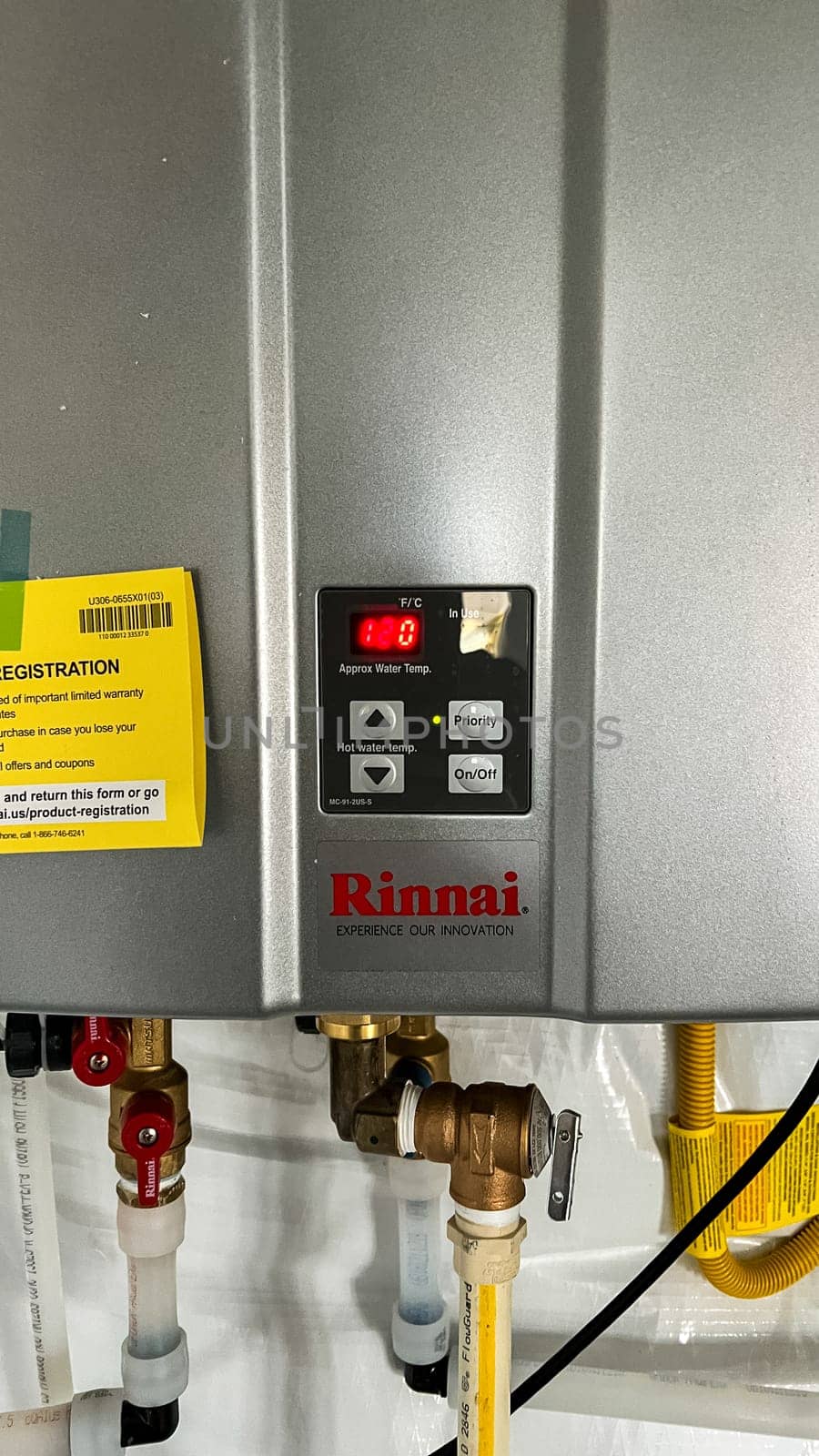Parker, Colorado, USA-January 11, 2023-A Rinnai tankless water heater installed in the basement of a newly constructed residential home. The energy-efficient unit provides on-demand hot water and features an Energy Guide label for performance specifications.