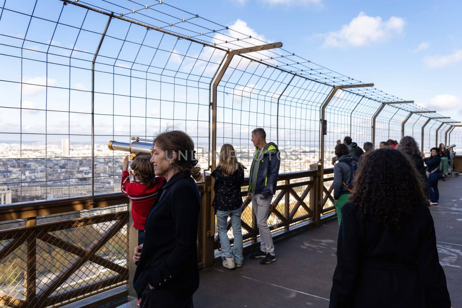 Tourists on the observation deck at the top of the Eiffel Tower. Paris, France - November 15, 2024