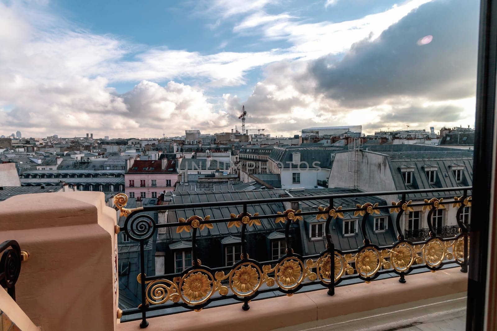 View to the roofs of buildings in Paris and the sky with clouds, France. High quality photo