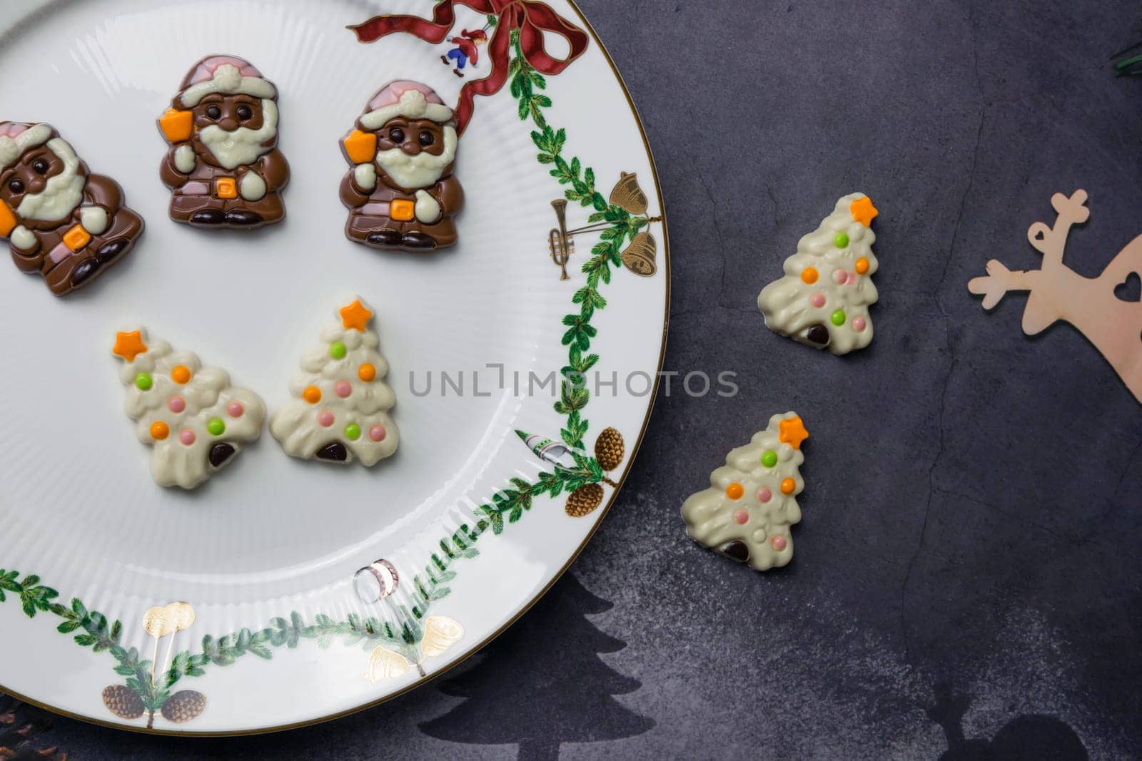 Christmas chocolates. Chocolate Santa Claus in a Christmas plate. High quality photo