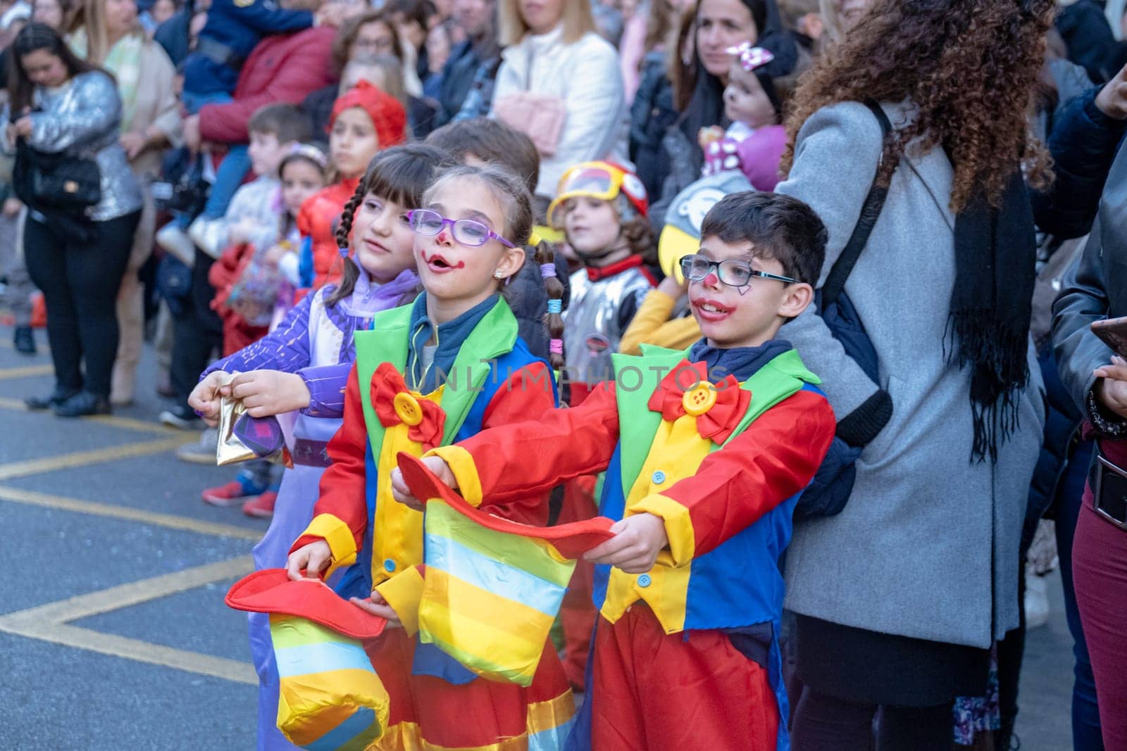 Joyful Kids in Jester Costumes at Outdoor Event