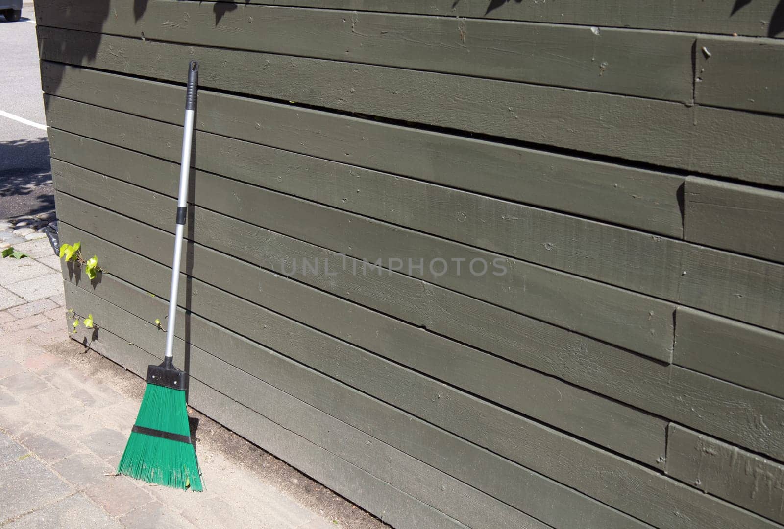 Broom on clean street, outdoors cleaning. City cleaning service. High quality photo