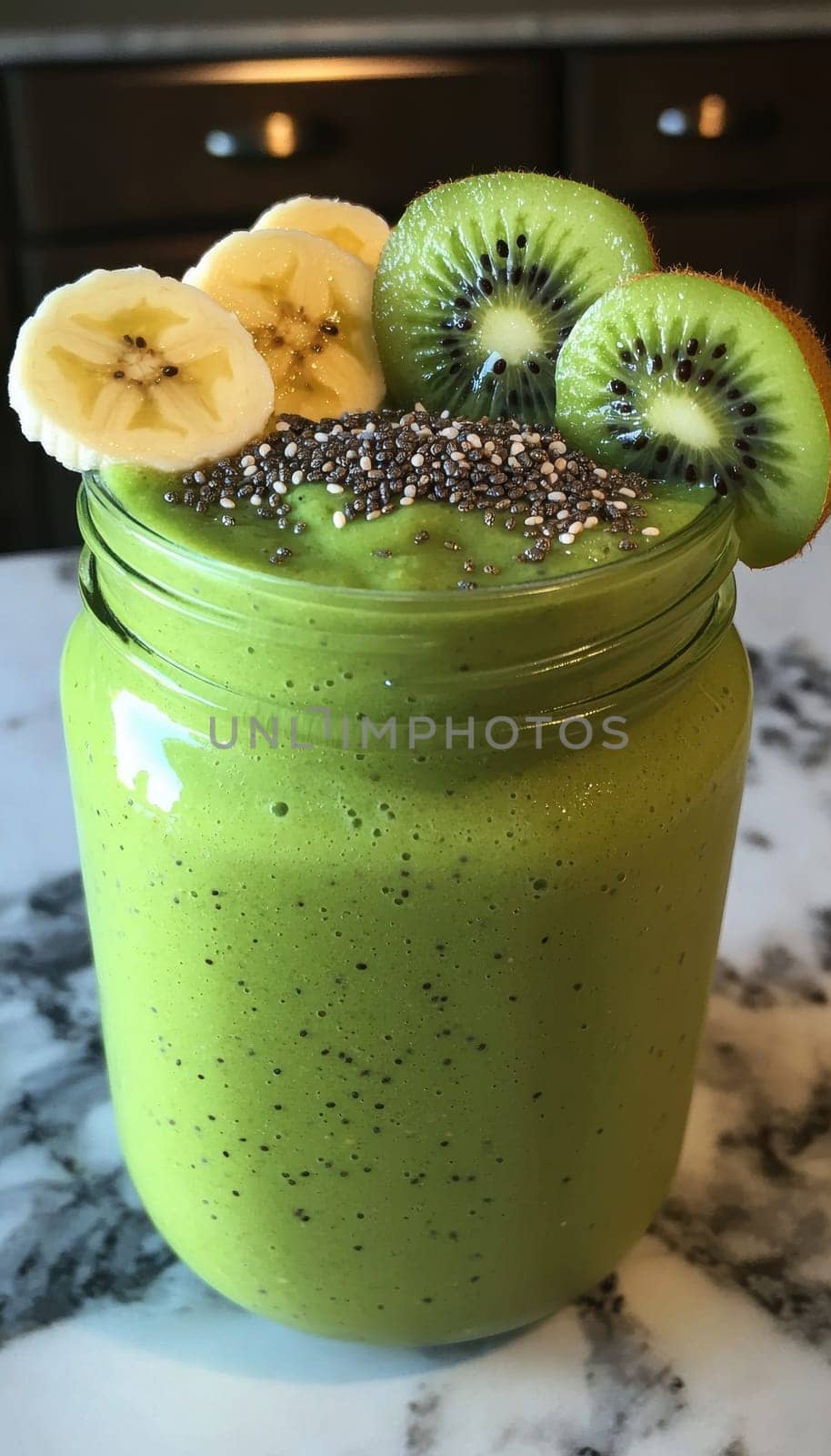 Refreshing green smoothie in a jar, enhanced by layered toppings of chia seeds, sliced bananas, and kiwis. the vivid colors and healthy ingredients make it ideal for nutrition-focused promotions and healthy lifestyle visuals.