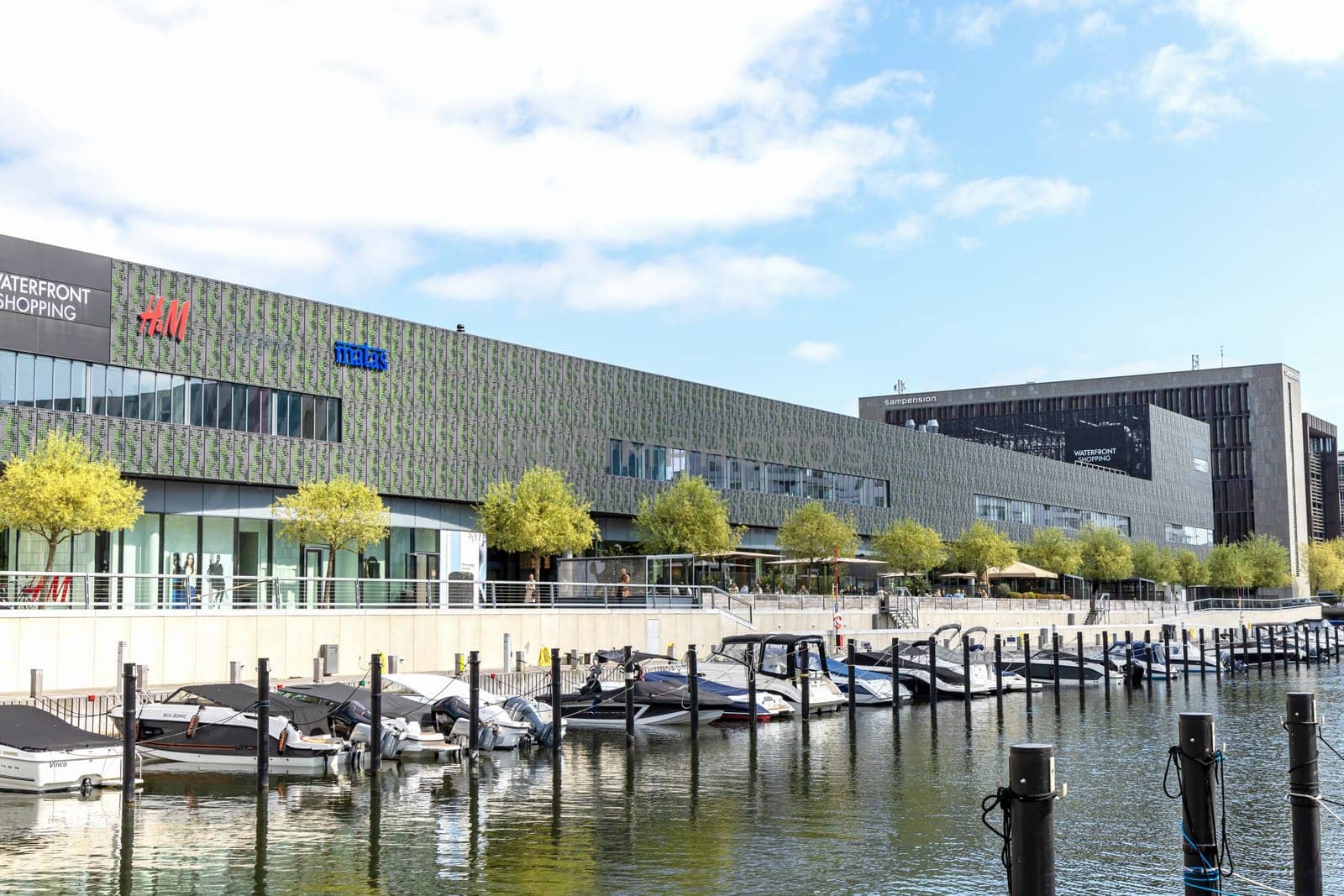 Shopping center and pier for boats and yachts in an expensive area of Copenhagen, Denmark - September 11, 2023.