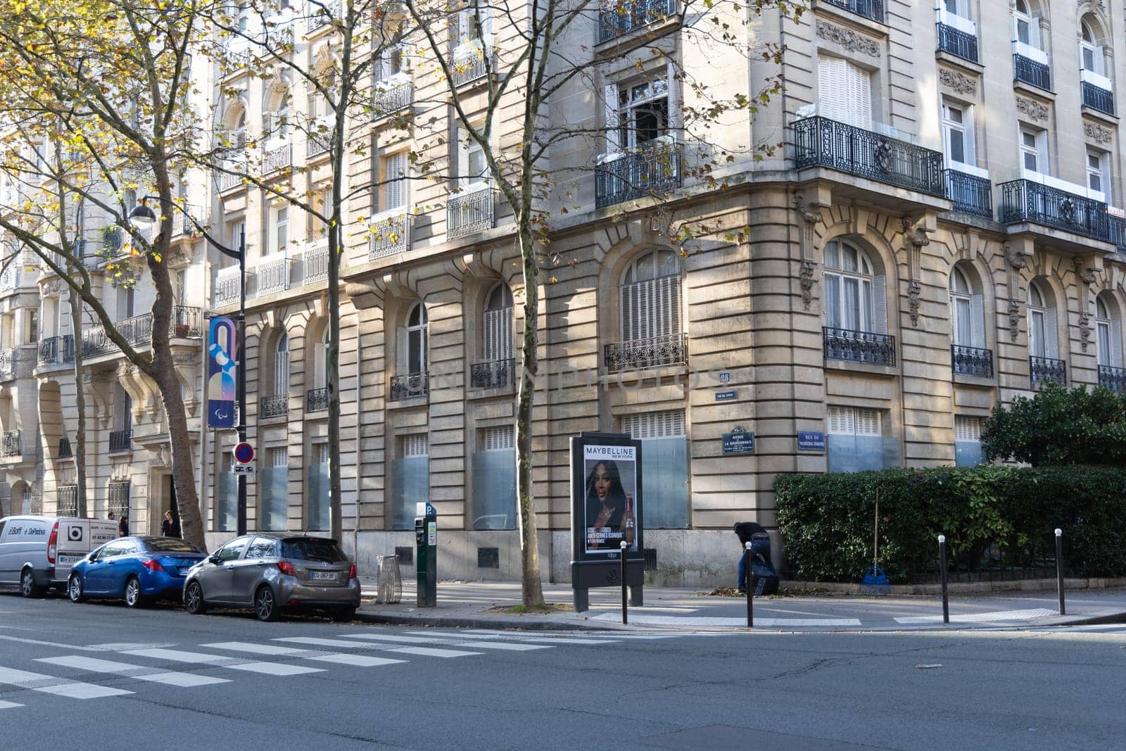 Street in Paris with beautiful buildings and parked cars. Paris, France - October 30, 2024