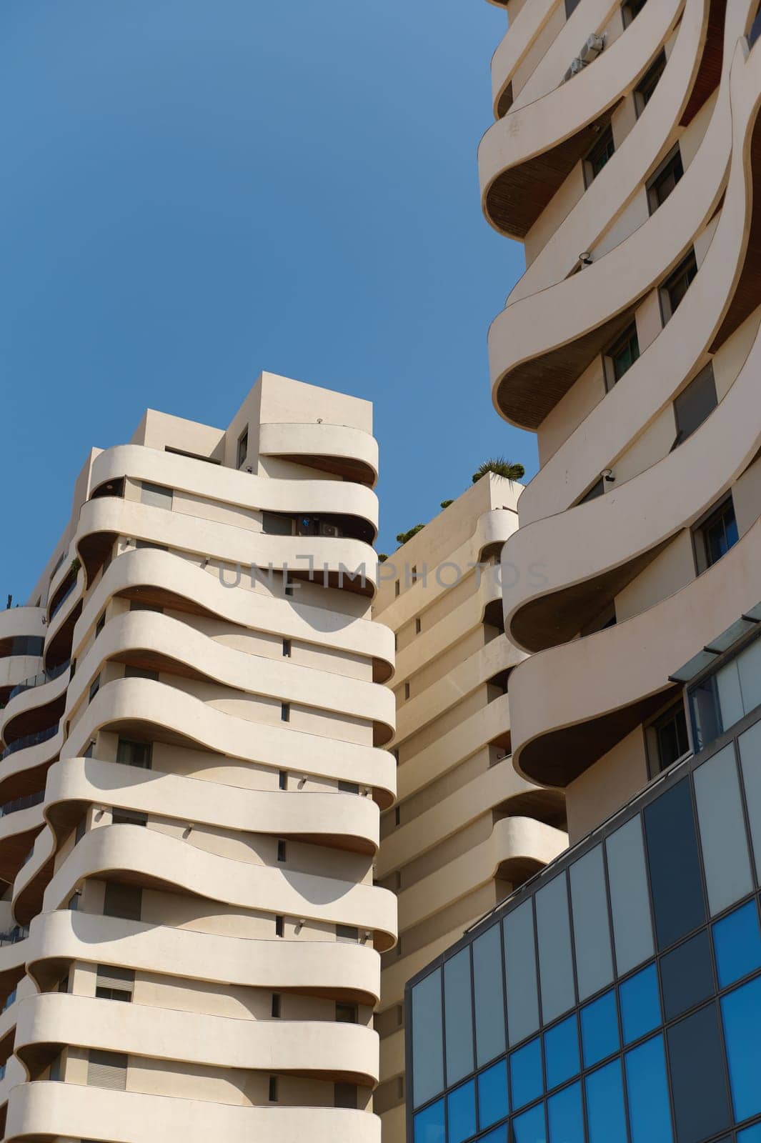 Vertical photography of a modern office building and business center. Growing up business. Architecture and contemporary design exterior concept. Upward perspective. Real estate concept. Copy space