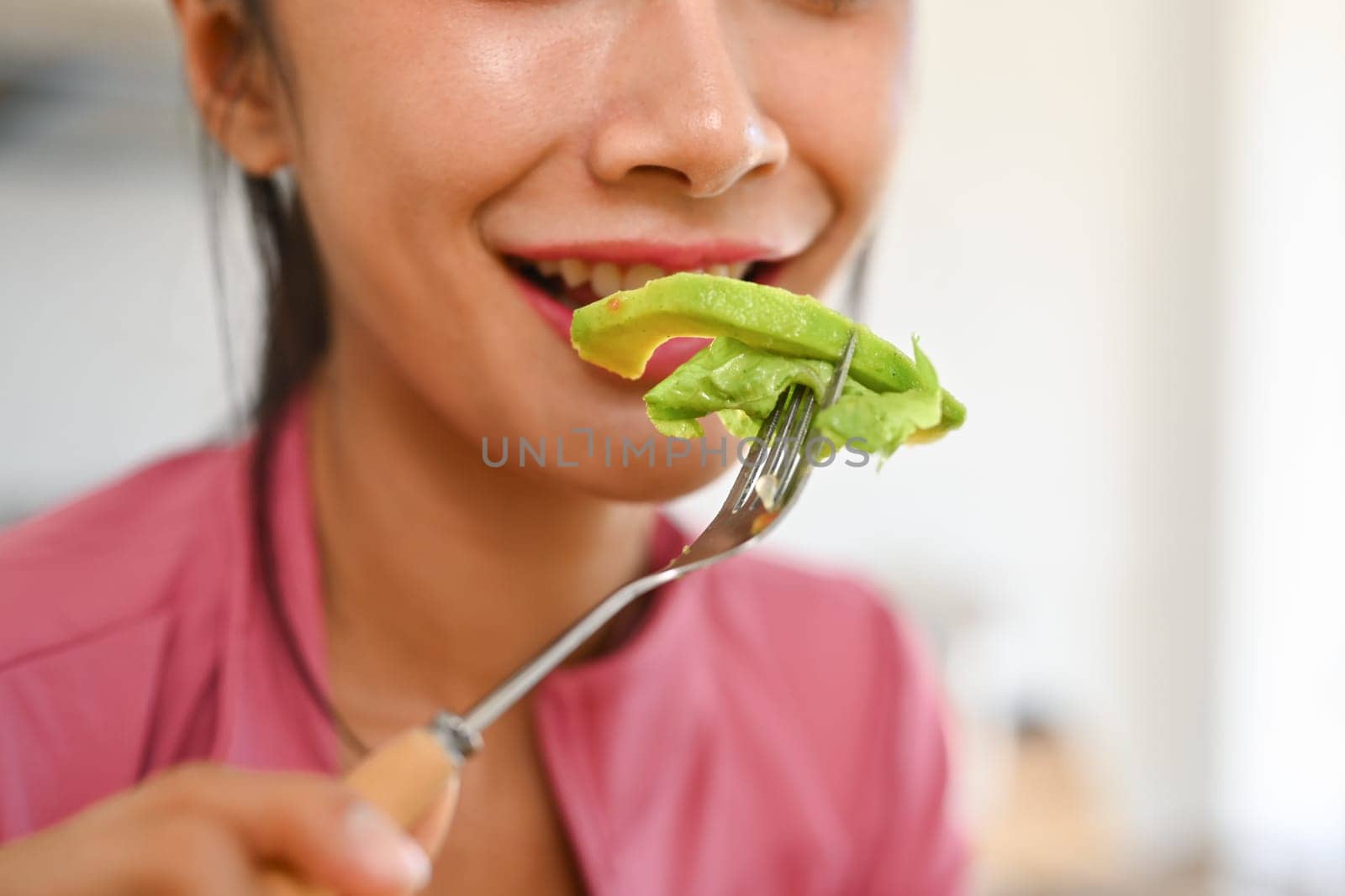 Young woman eating vegetable salad. Healthy eating, dieting snd wellbeing concept by prathanchorruangsak