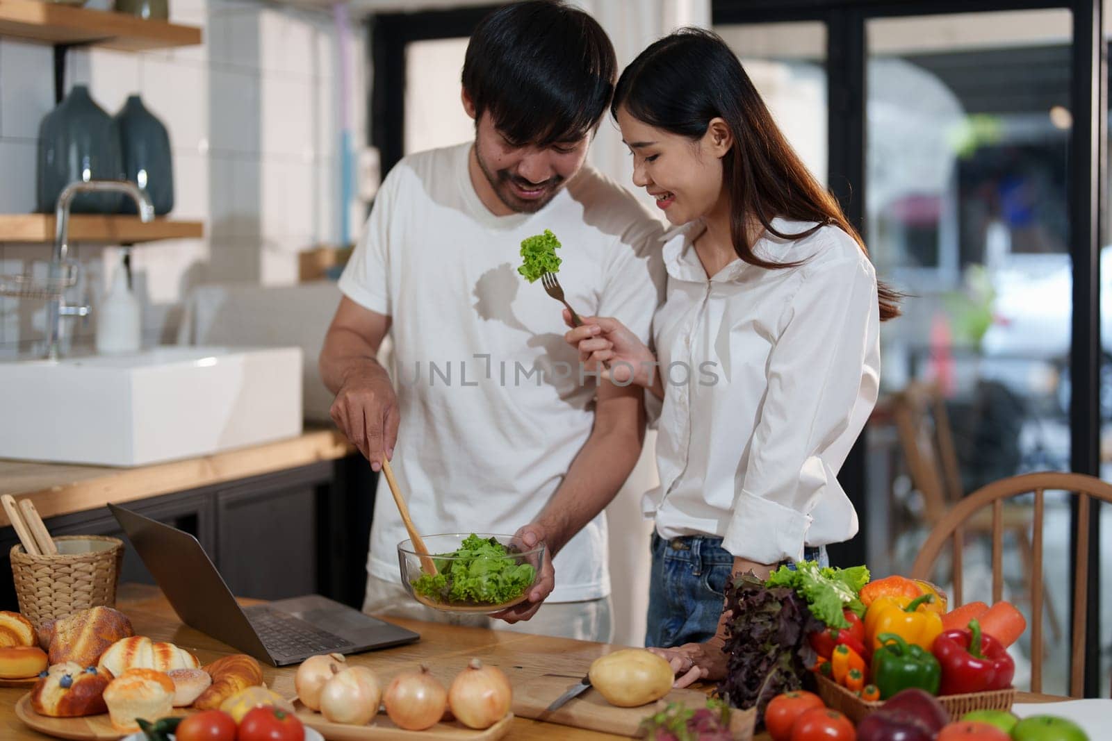 Couple making food or salad in the kitchen at home