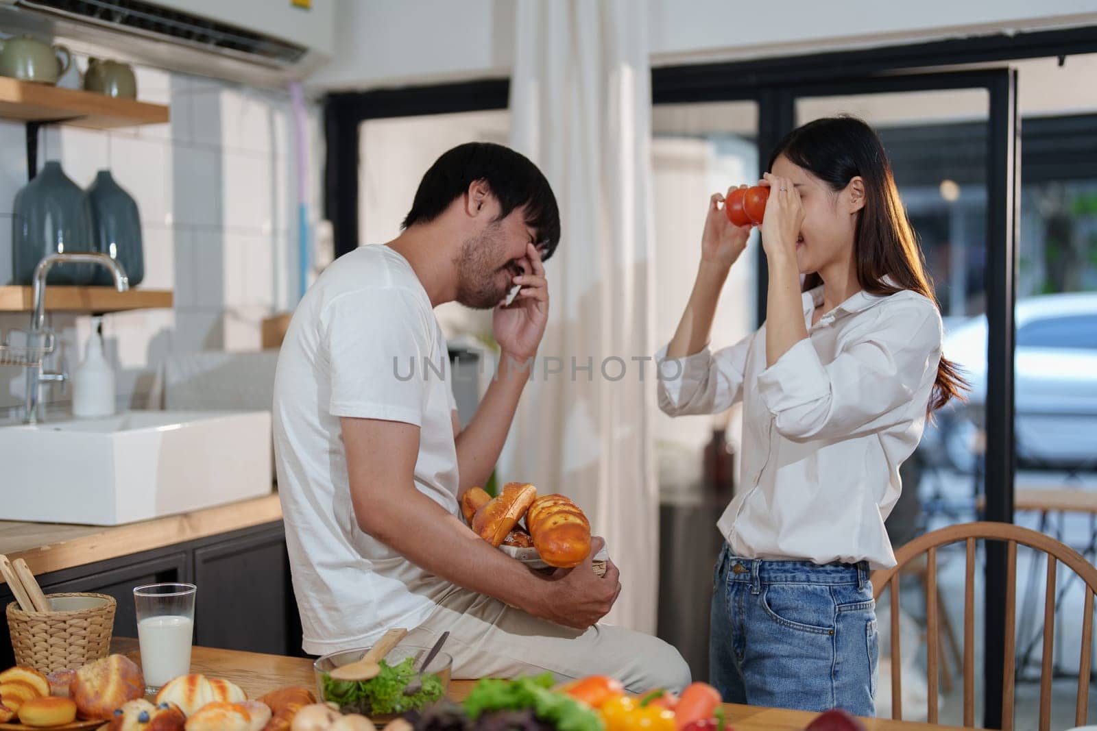 Couple making food or salad in the kitchen at home