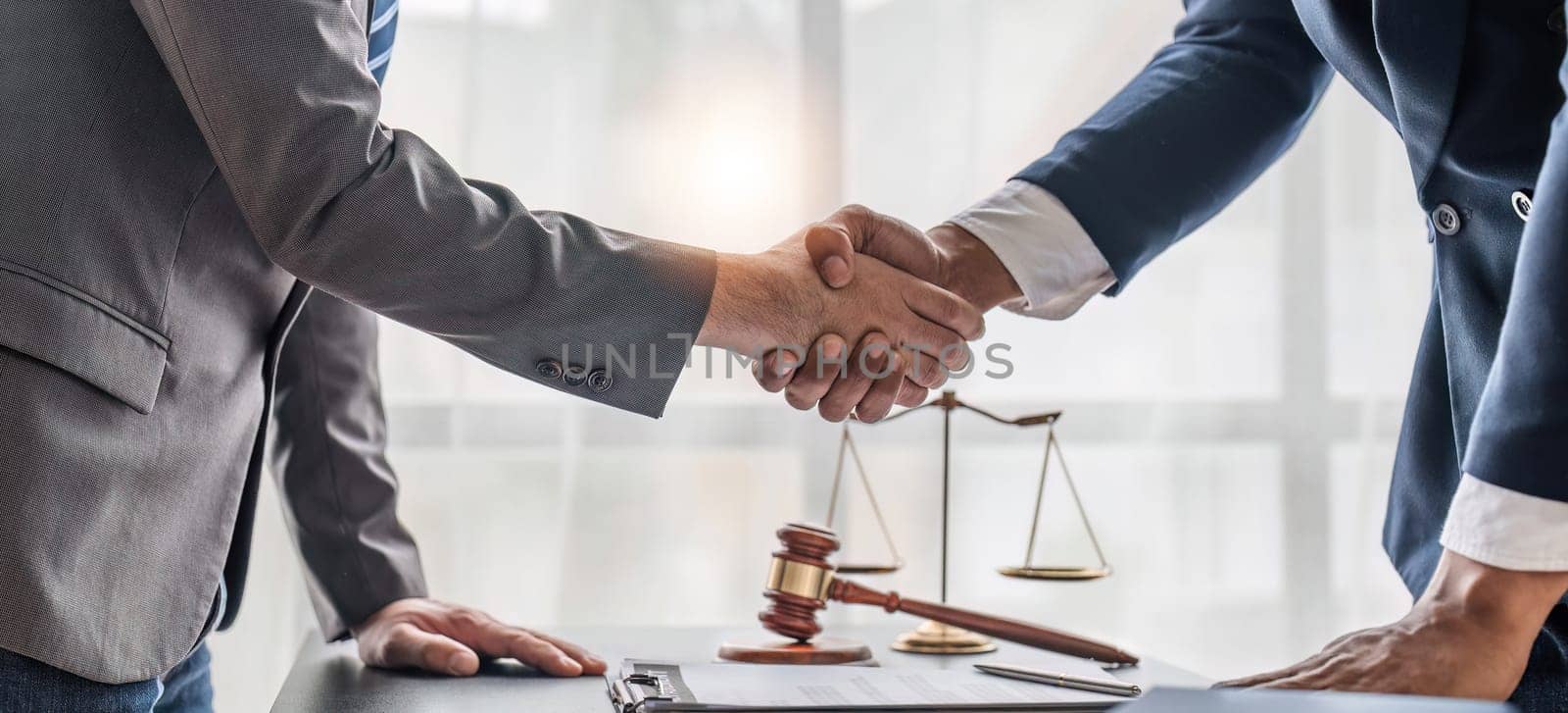 Successful consultations Consultation and meeting Lawyers and business professionals working and discussing with law firms in the office shake hands and congratulate each other. by wichayada