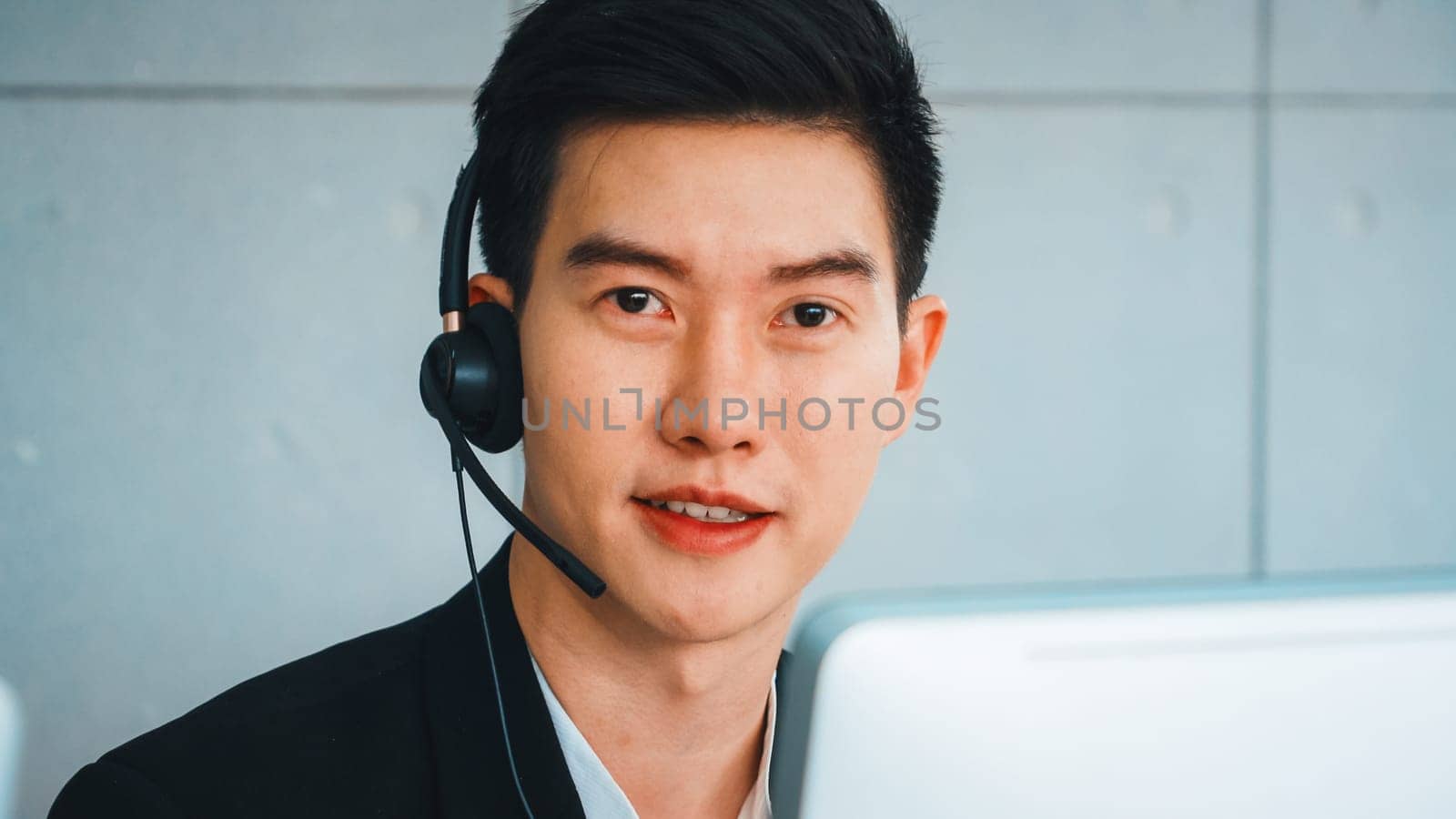 Business people wearing headset working in office to support remote customer or colleague. Call center, telemarketing, customer support agent provide service on telephone video conference call. Jivy