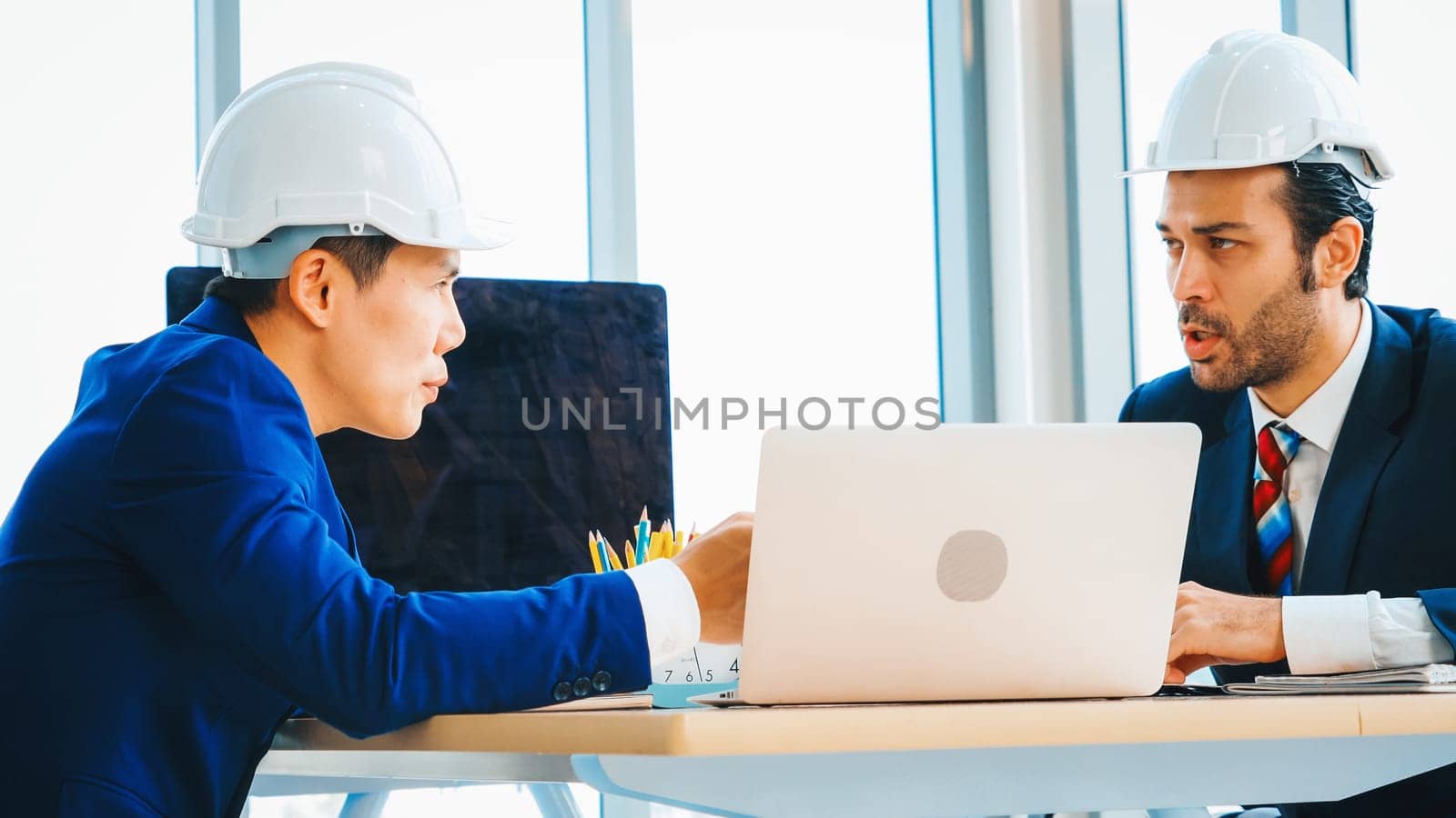 Engineer and architect meeting at office table Jivy by biancoblue