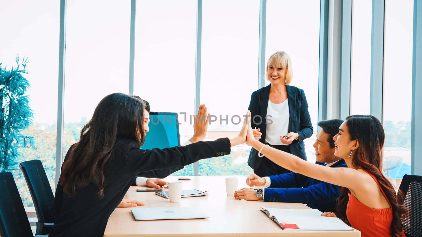 Business people in the conference room with green screen chroma key TV or computer on the office table. Diverse group of businessman and businesswoman in meeting on video conference call . Jivy