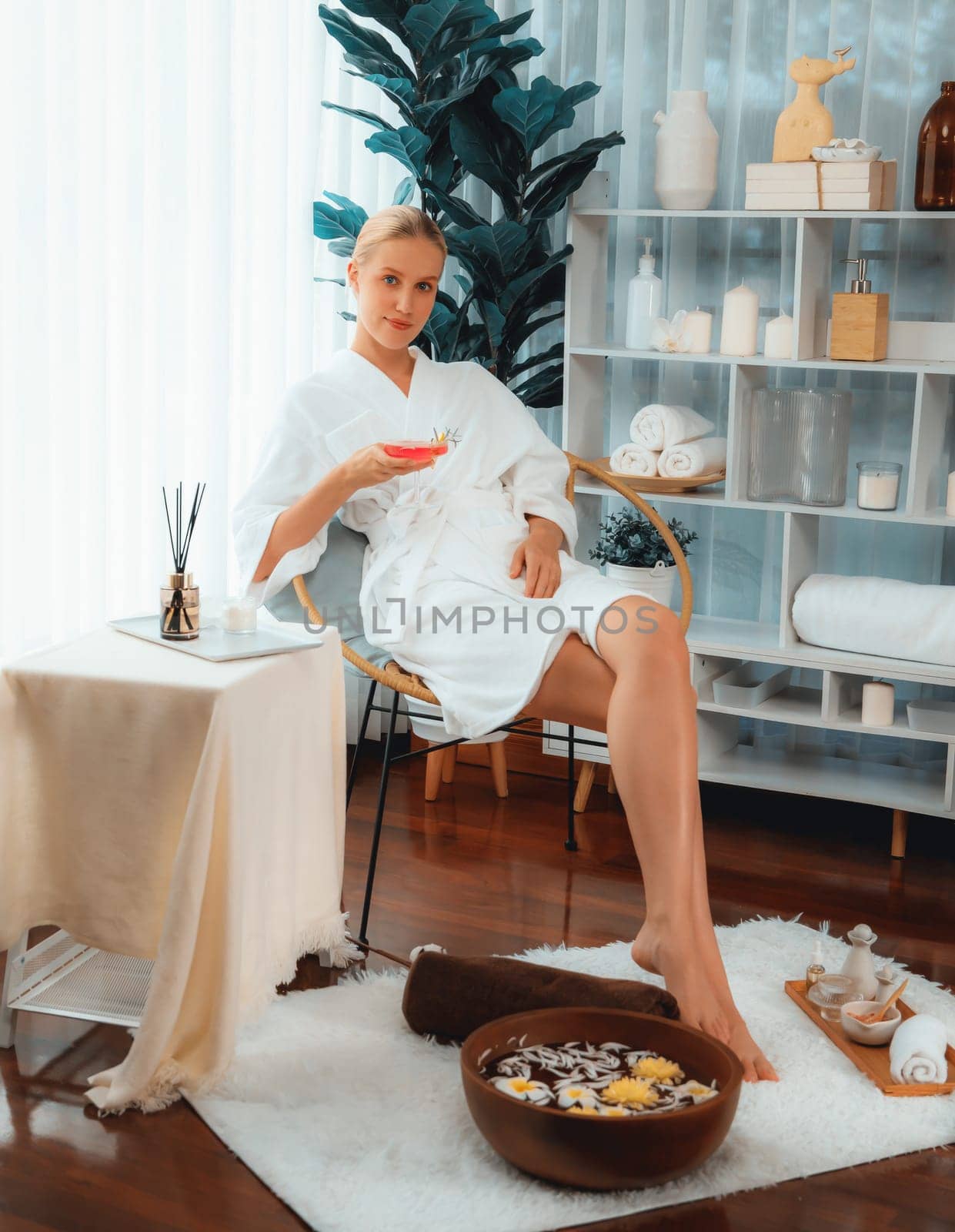 Woman indulges in blissful foot massage at luxurious spa salon while masseur give reflexology therapy in gentle day light ambiance resort or hotel foot spa. Quiescent