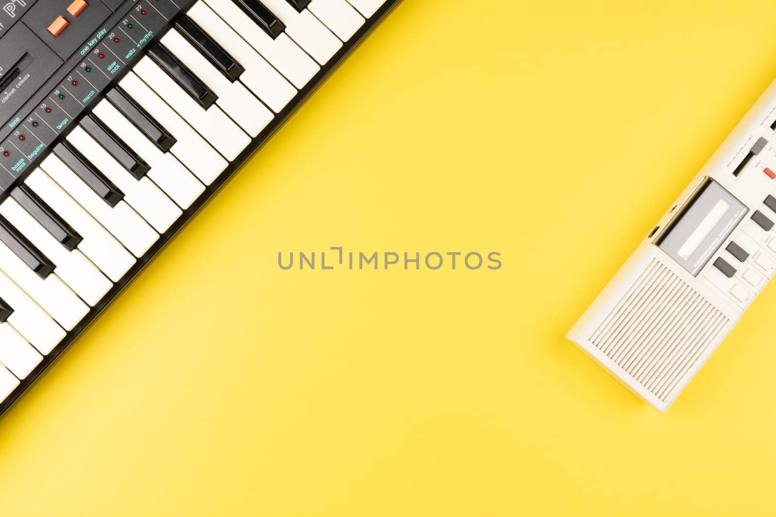 Vintage electronic keyboard synth piano on yellow background by TropicalNinjaStudio