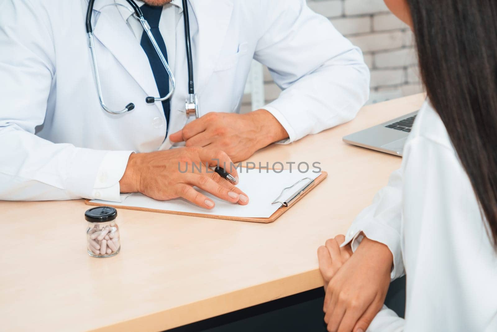 Doctor in professional uniform examining patient at hospital Jivy by biancoblue