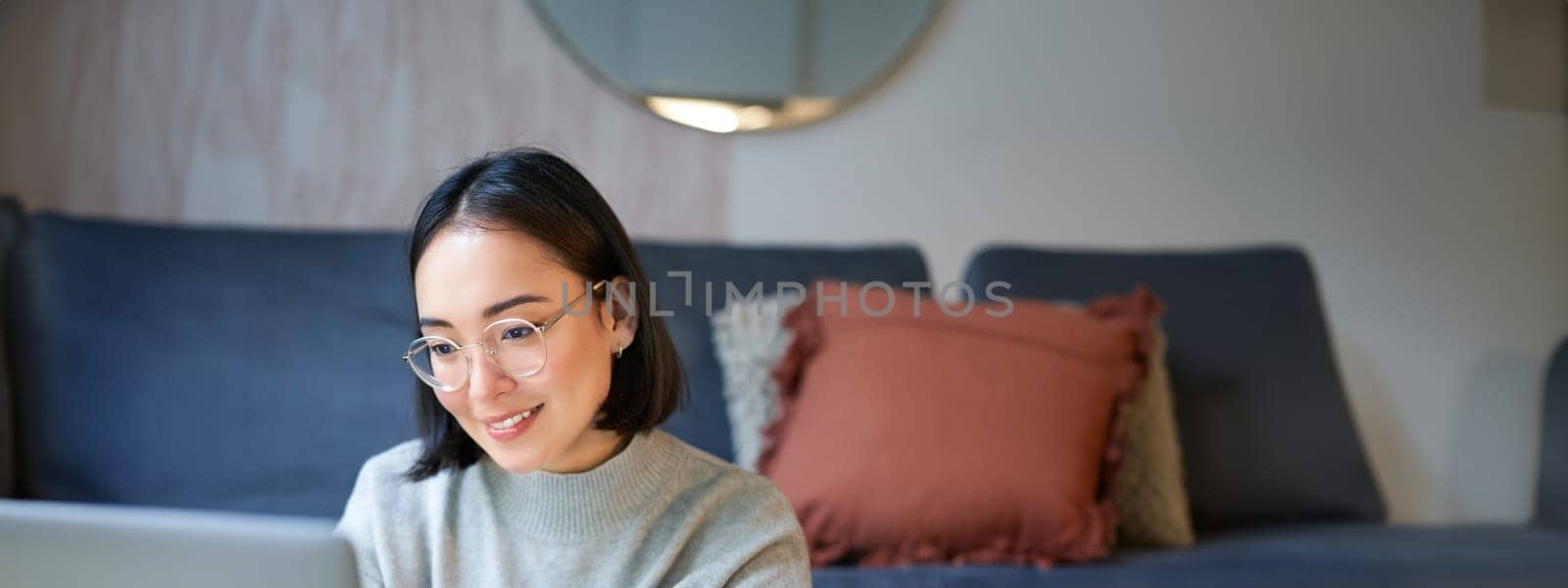 Portrait of working businesswoman using laptop, work on remote. Korean girl with computer, shops online by Benzoix