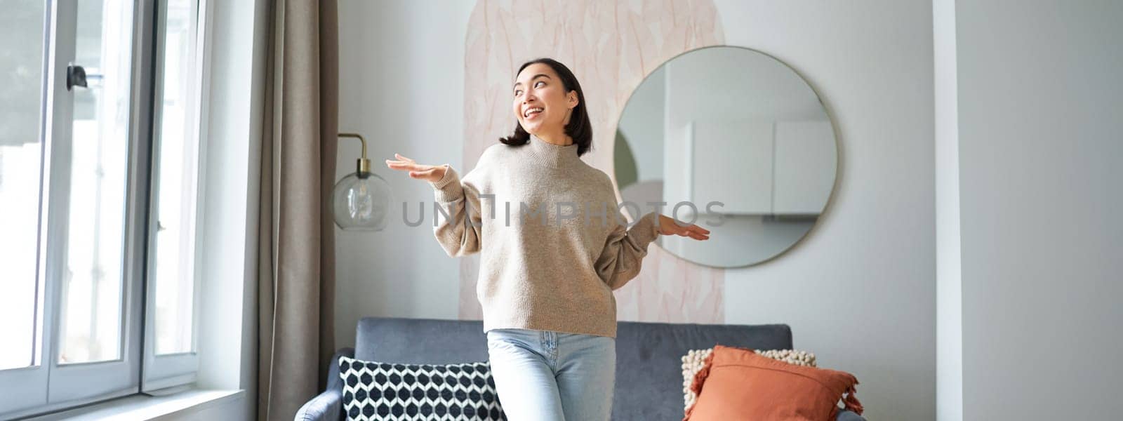 People and emotions. Joyful teen girl dancing in her room, feeling happy and carefree, concept of joy and satisfaction.