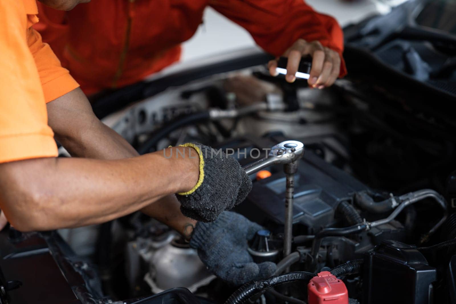 Automotive service mechanic inspect and diagnose car engine issue, repairing and fixing problem in garage workshop. Technician car care maintenance working on internal components of vehicle. Oxus