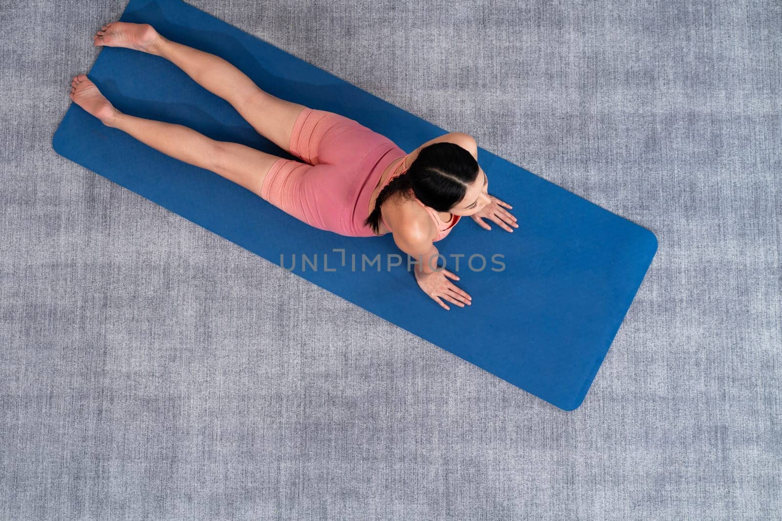 Top view asian woman in sportswear doing yoga exercise. Vigorous by biancoblue