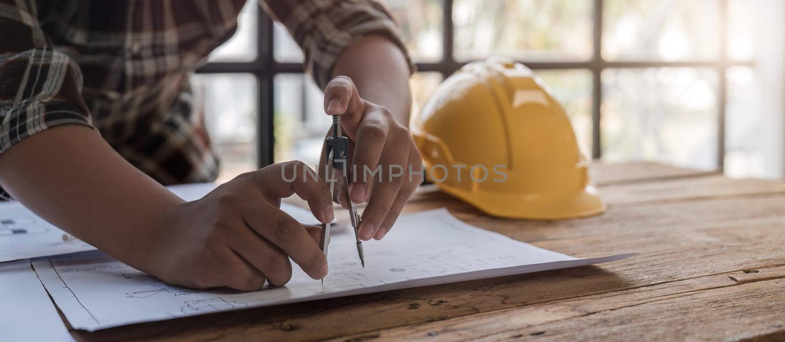 Team of civil engineers meeting at construction site in modern city To plan the work and layout of the project. by wichayada