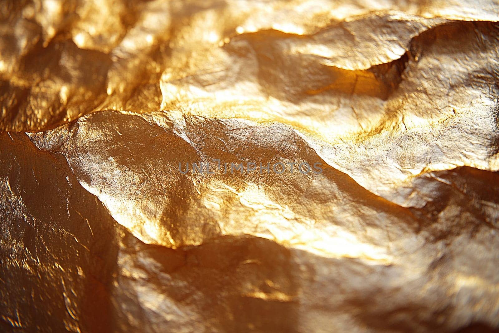Gold foil texture with dents for luxury design. Abstract grunge metallic surface. Versatile gold background for creative projects