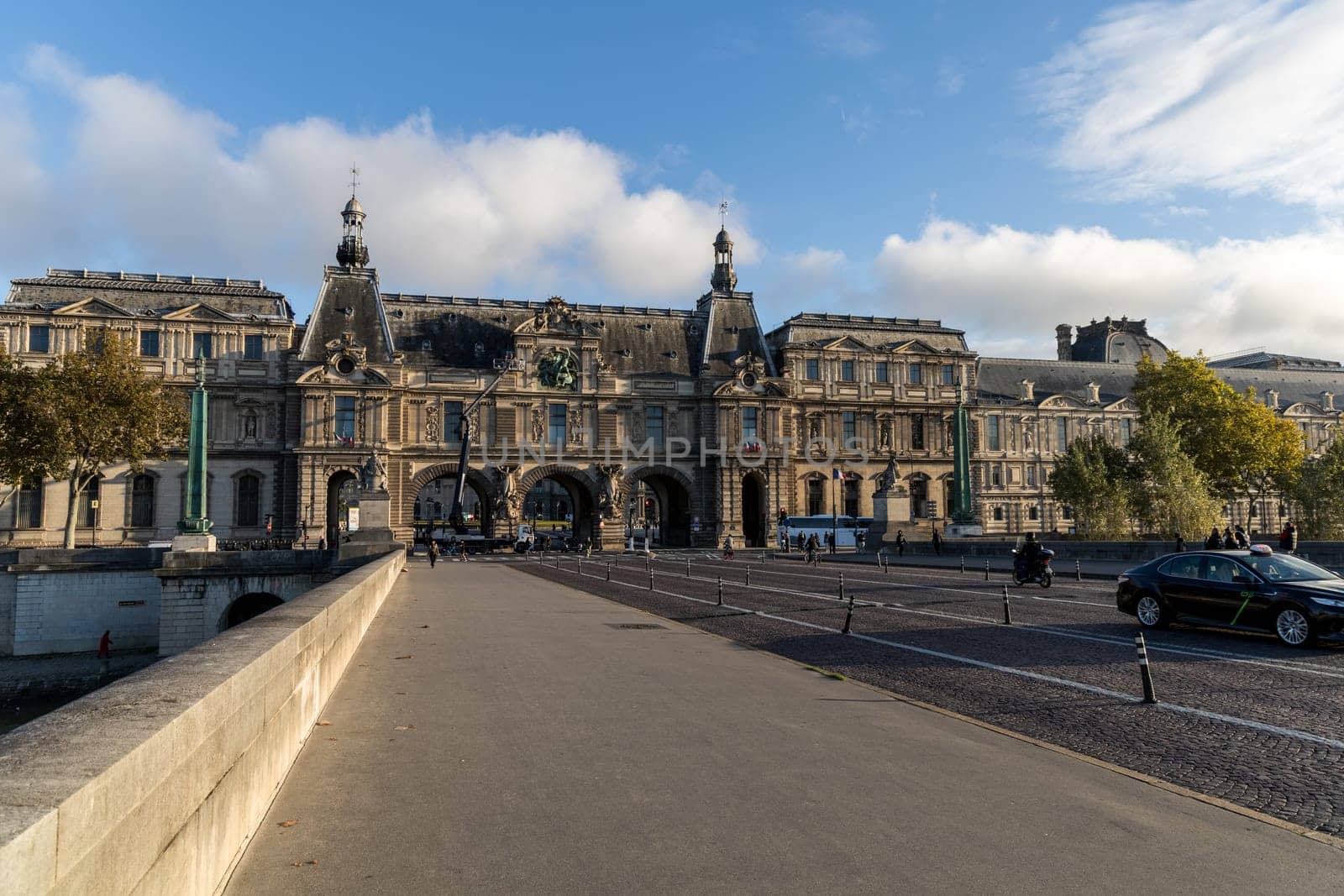 A stunning view of the Louvre Museums entrance against clear skies, showcasing its beautiful architecture. Paris, France - October 24, 2024