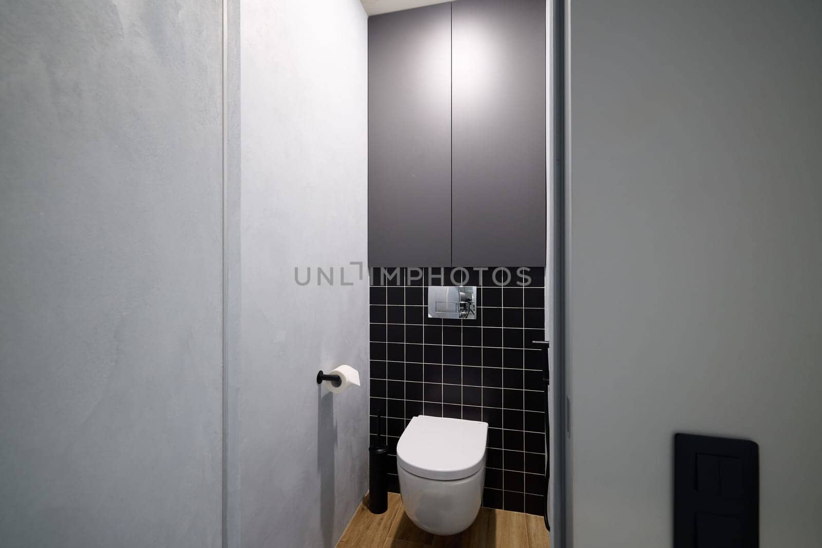 This sleek, modern bathroom design features a stunningly minimalist toilet alongside stylish cabinetry options