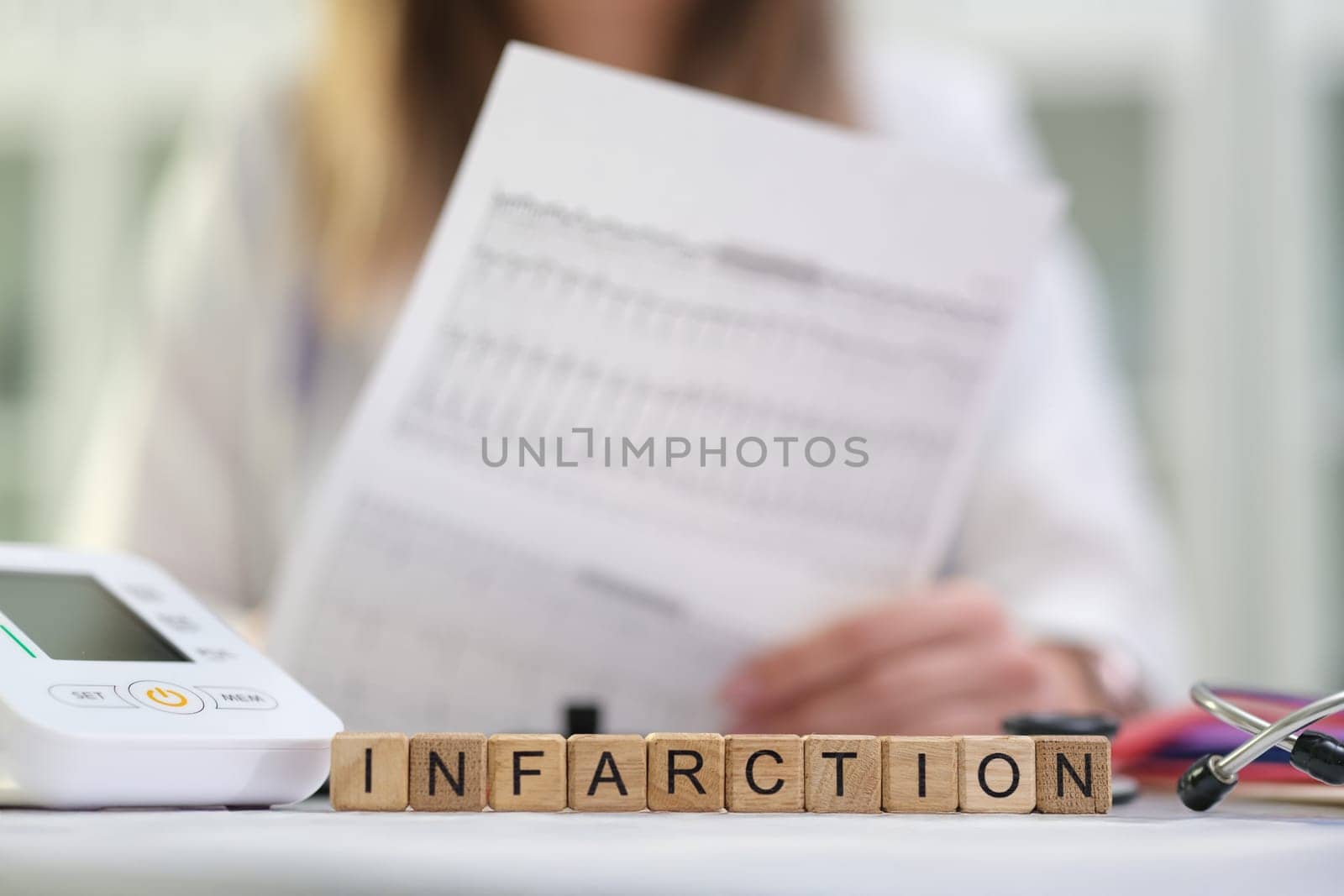 A skilled healthcare professional is systematically analyzing critical infarction data using advanced medical equipment