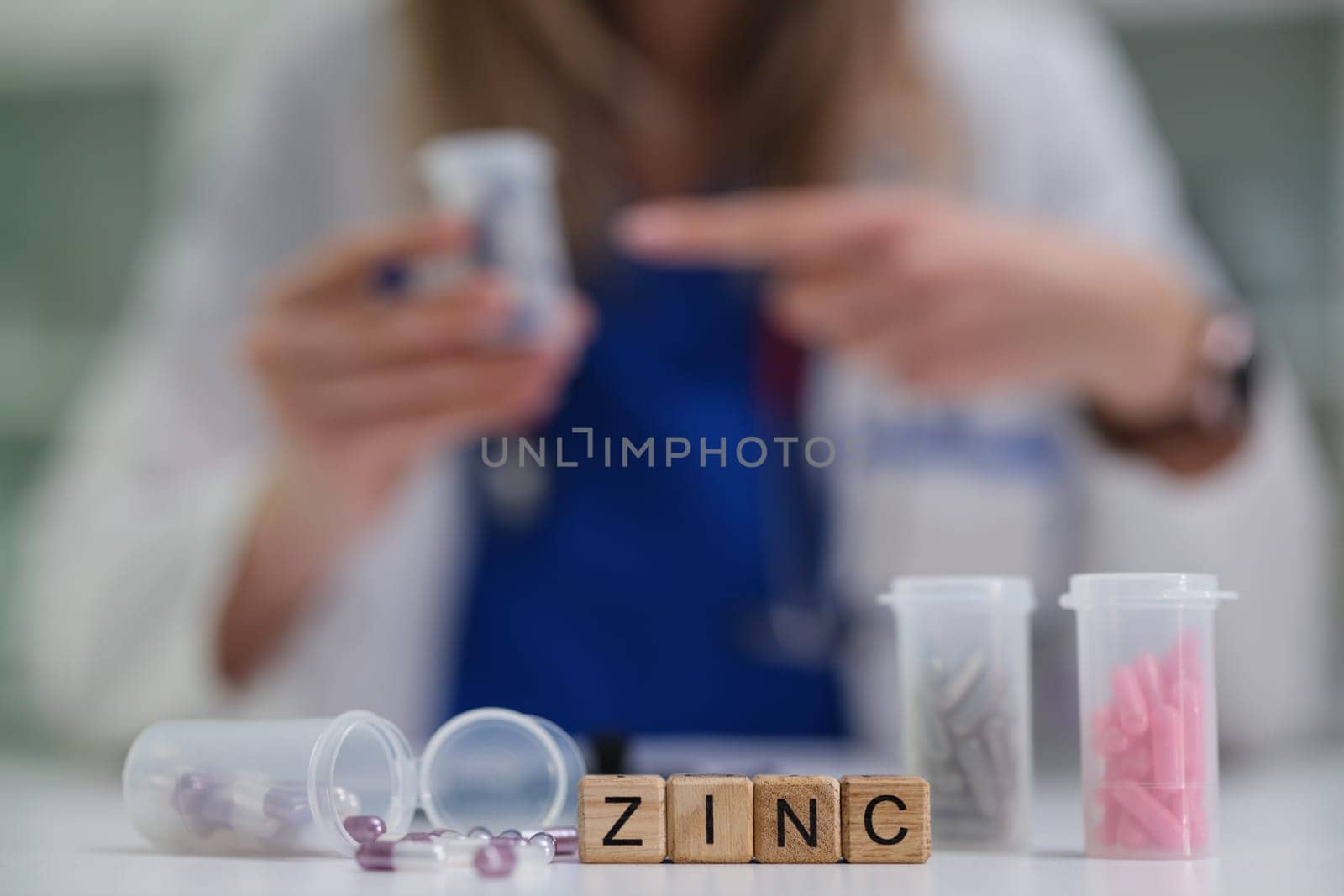 A healthcare professional is sorting different zinc supplements in a pharmacy filled with colorful containers