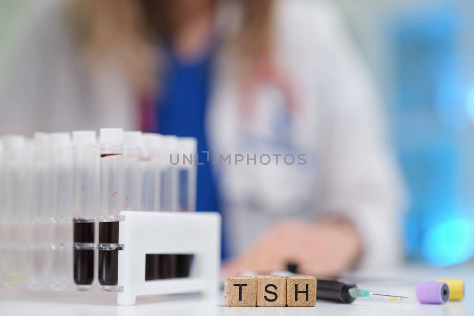 A qualified medical professional is carefully examining blood samples for TSH testing in a specialized laboratory