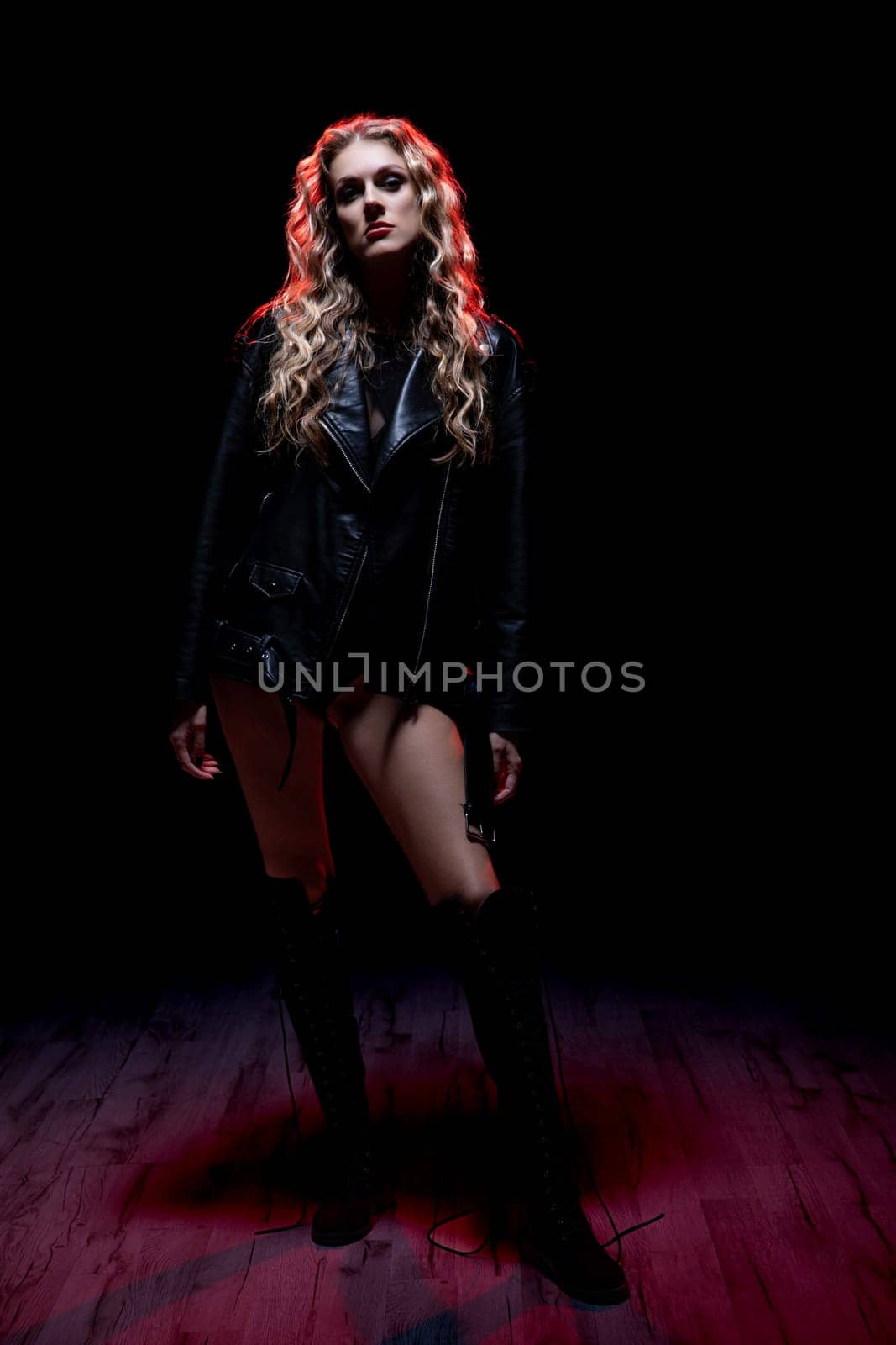 An eyecatching fashion portrait showcasing a model adorned in edgy and stylish attire against a dark backdrop