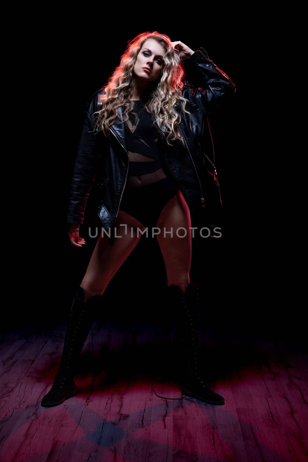 A striking portrait of a confident woman in a leather jacket, showcasing modern fashion and attitude.