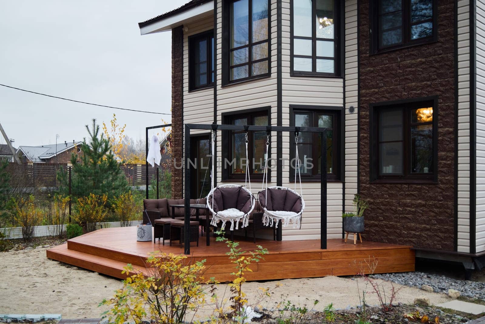 This charming modern house features a stylish deck that is perfect for relaxation and enjoying outdoor gatherings