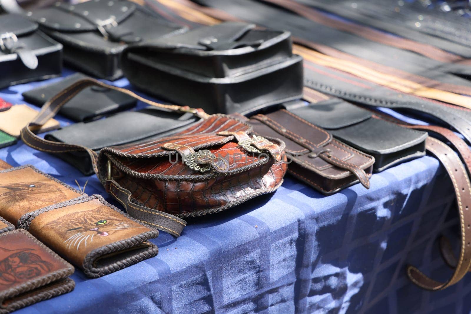 Explore a wide variety of unique and beautifully handcrafted leather bags and accessories showcased at a local market