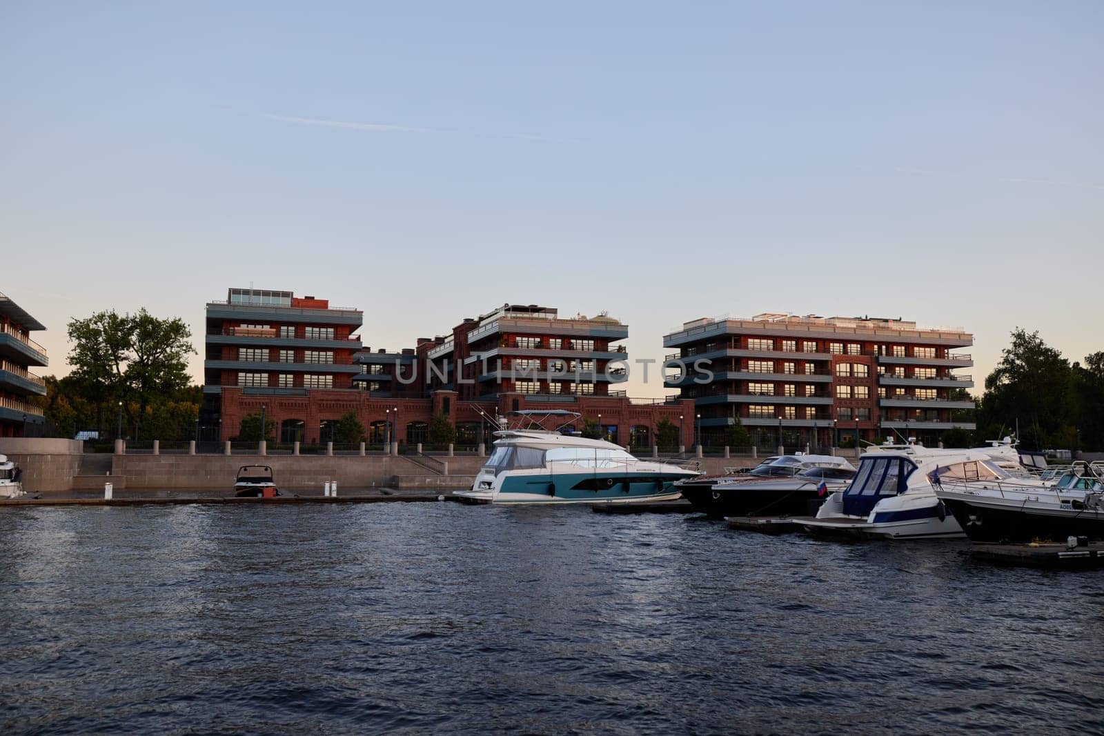 Elegant modern waterfront apartments set alongside exclusive luxurious yachts and tranquil serene water views