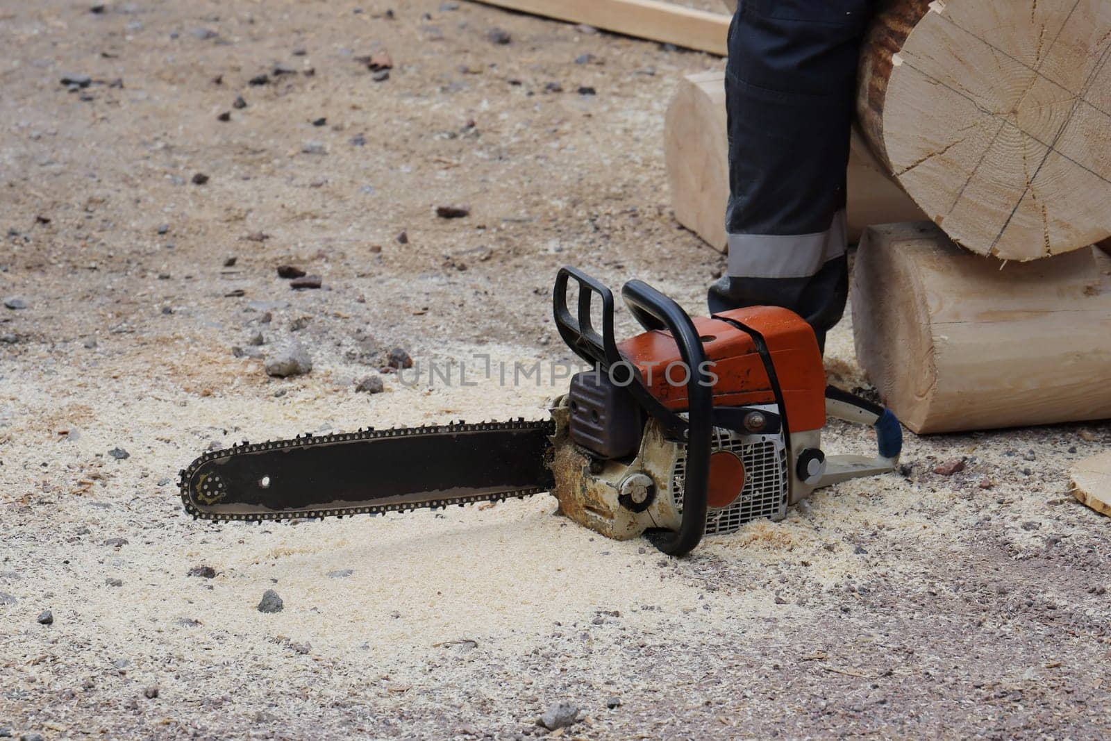This image shows a closeup of a chainsaw cutting wood, highlighting the dynamic action and craftsmanship involved