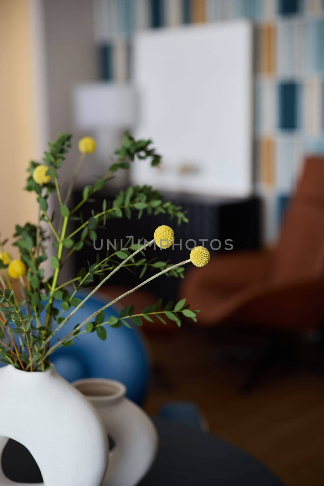 A contemporary living space that showcases a beautiful decorative vase alongside vibrant yellow flowers
