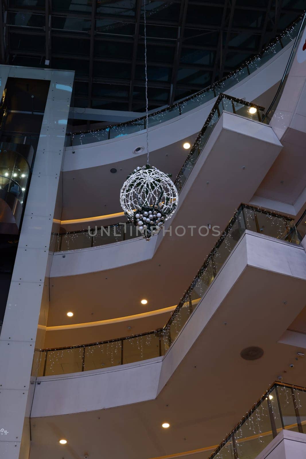 A beautifully styled lobby that features a grand and stunning chandelier along with an elegant open staircase design