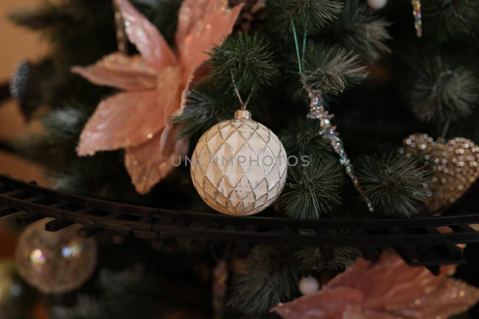 A stunningly beautifully decorated Christmas tree adorned with exquisite elegant ornaments and floral accents in style