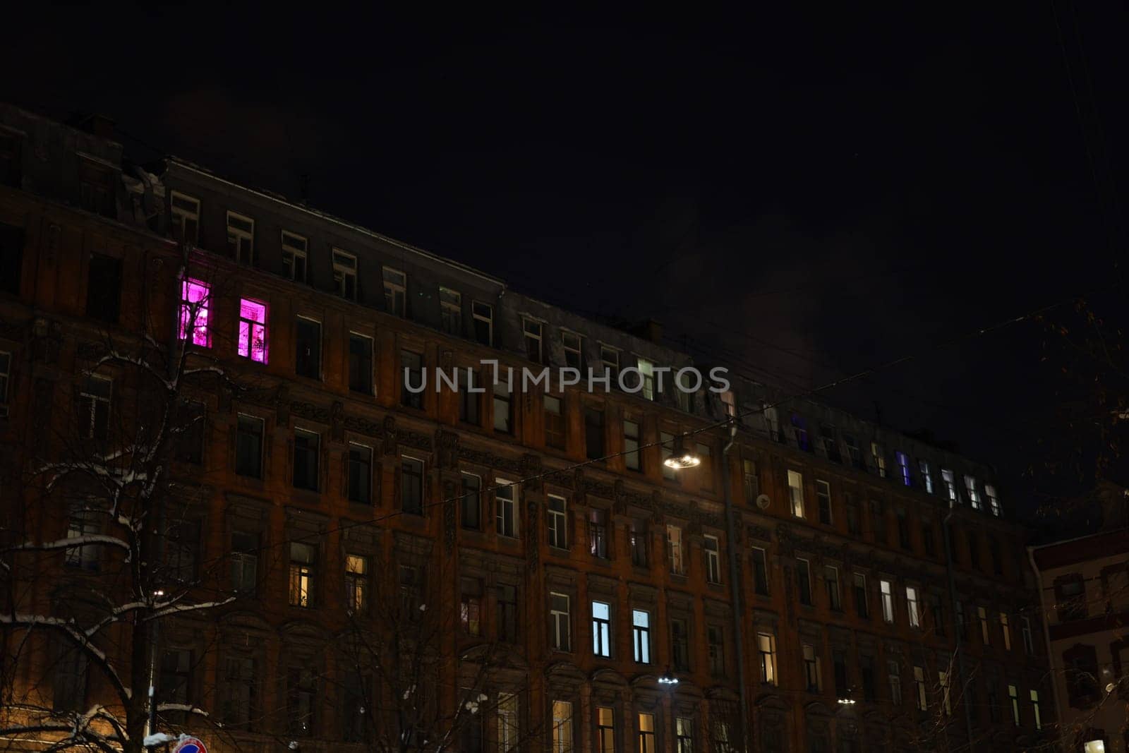 A truly captivating night scene that showcases a historic building beautifully illuminated by colorful window lights