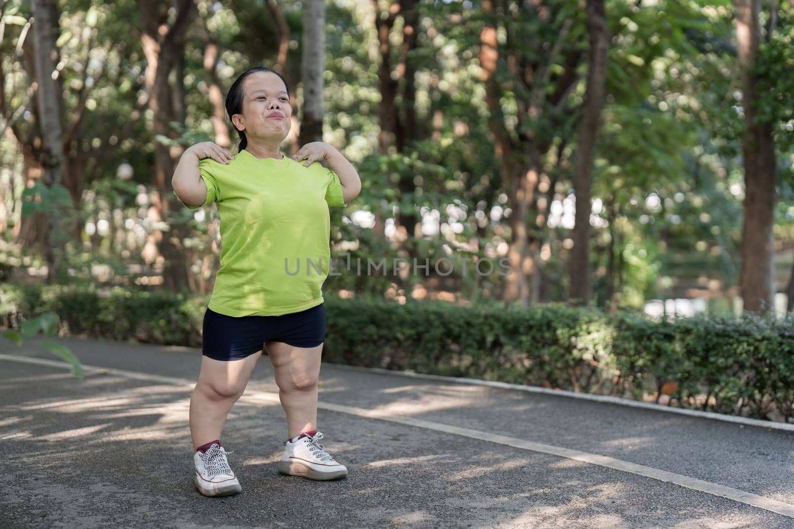 A woman jogs through a vibrant garden, enjoying the fresh air and natural surroundings while staying active and healthy.
