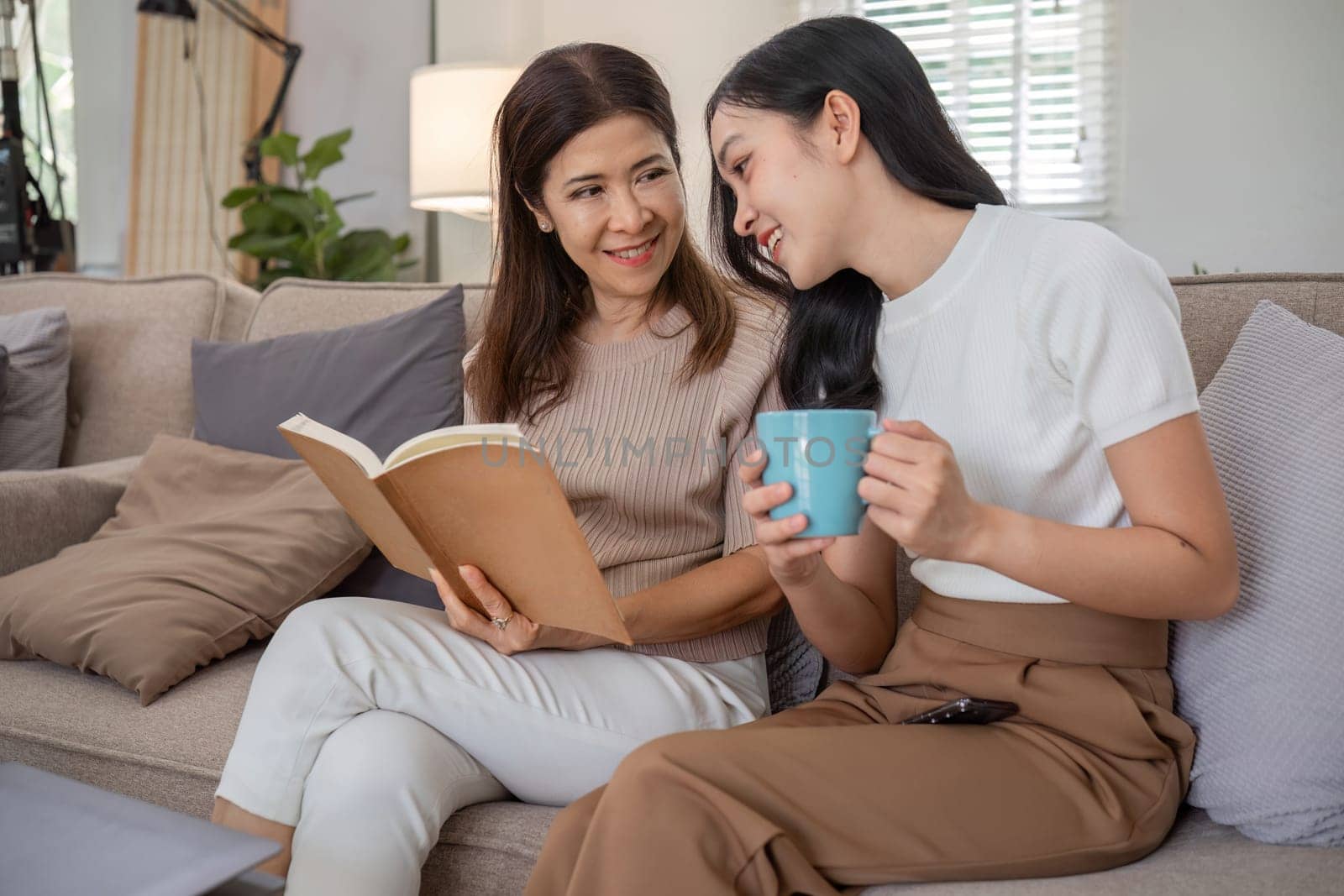 A mother and daughter enjoy quality time together arranging flowers, creating a warm and loving atmosphere at home.