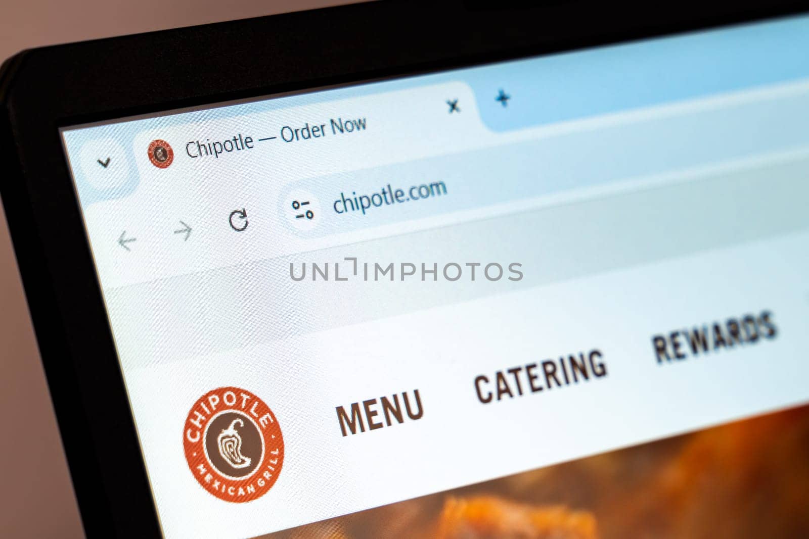 New York, USA - December 21, 2024: Chipotle website homepage displayed on a laptop screen with logo. Fast-casual restaurant chain offering Mexican-inspired food and catering services