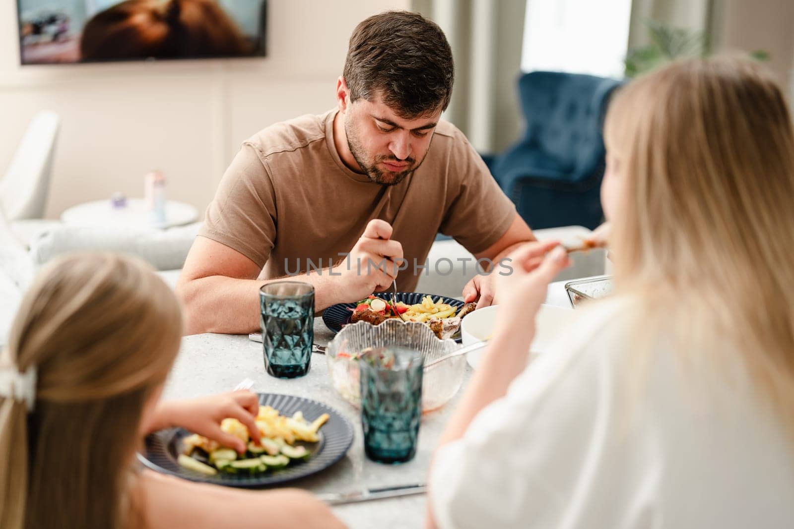 Family enjoying meal together in a modern kitchen close up